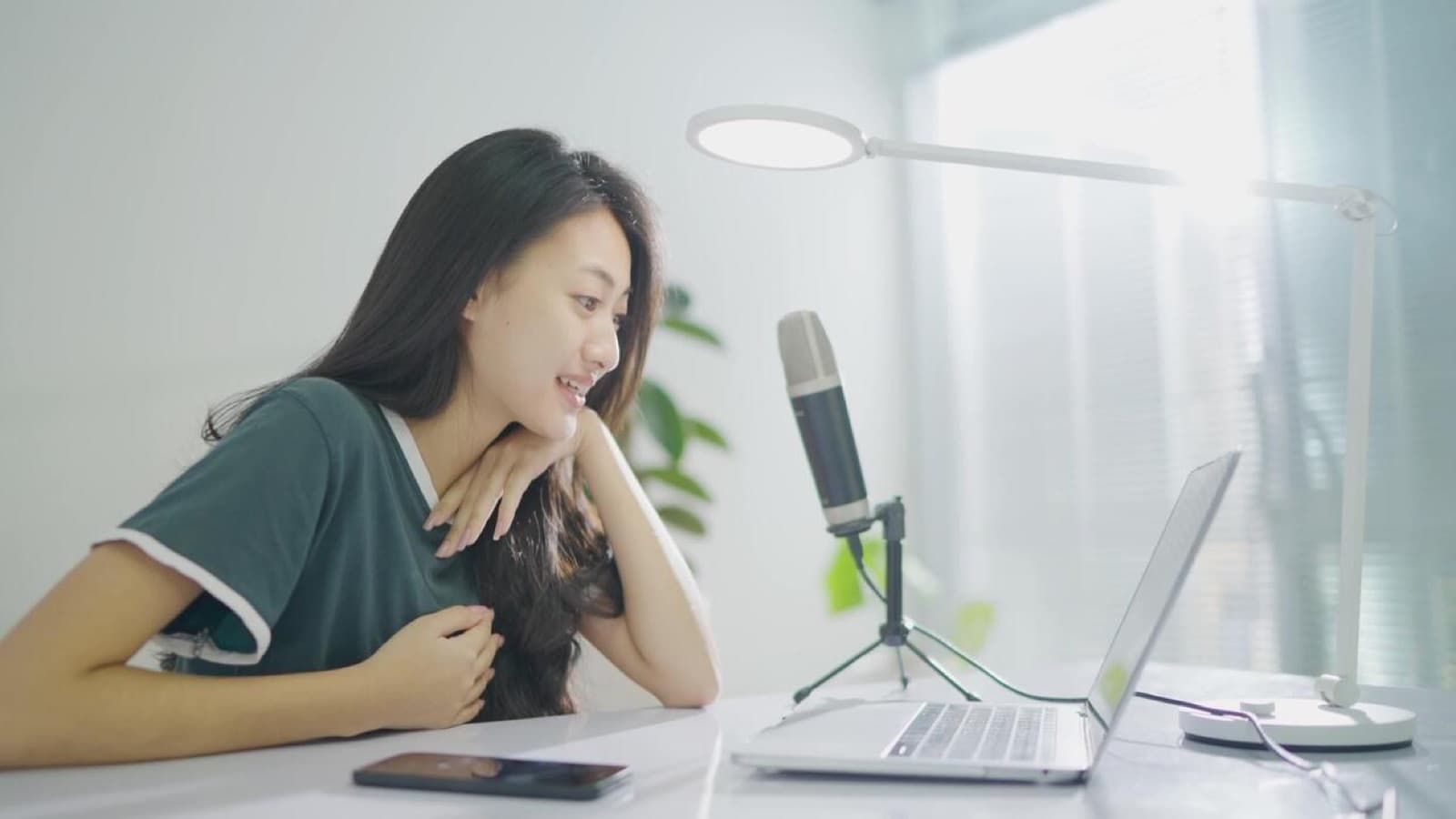 A person at a laptop recording a short personalized video